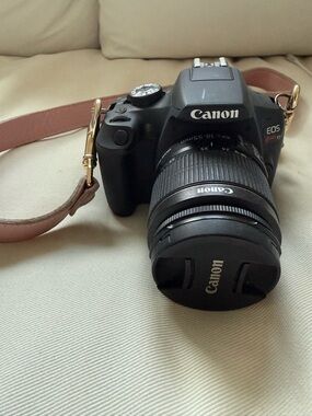 Canon DSLR Camera in Black with Brown Strap and 18-55mm Lens